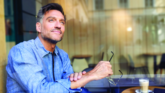 A man smiling in contemplation.