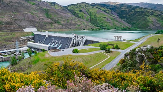 A landscape shot of a dam producing renewable hydroelectric energy.