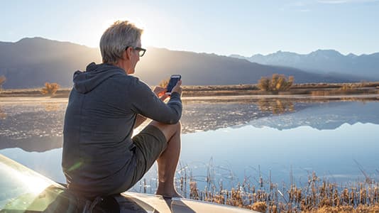A landscape shot of a man blocking the bright sun.